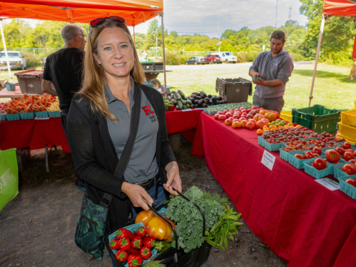 Lauren shops for vegetables at the farmers market
